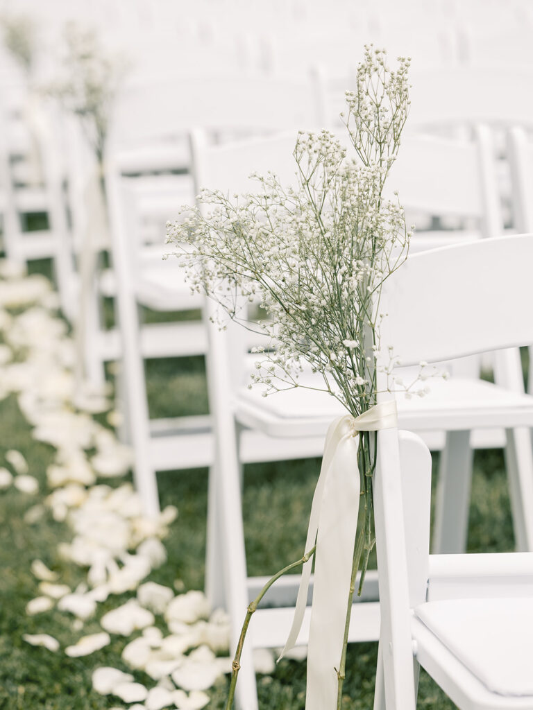 Baby breath aisle decor tied with ribbon at Bella Giornata wedding ceremony
