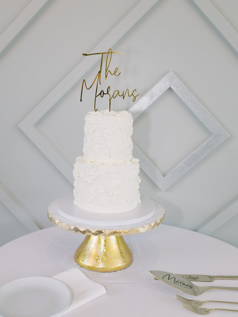 White wedding cake with gold acrylic topper at Bella Giornata reception